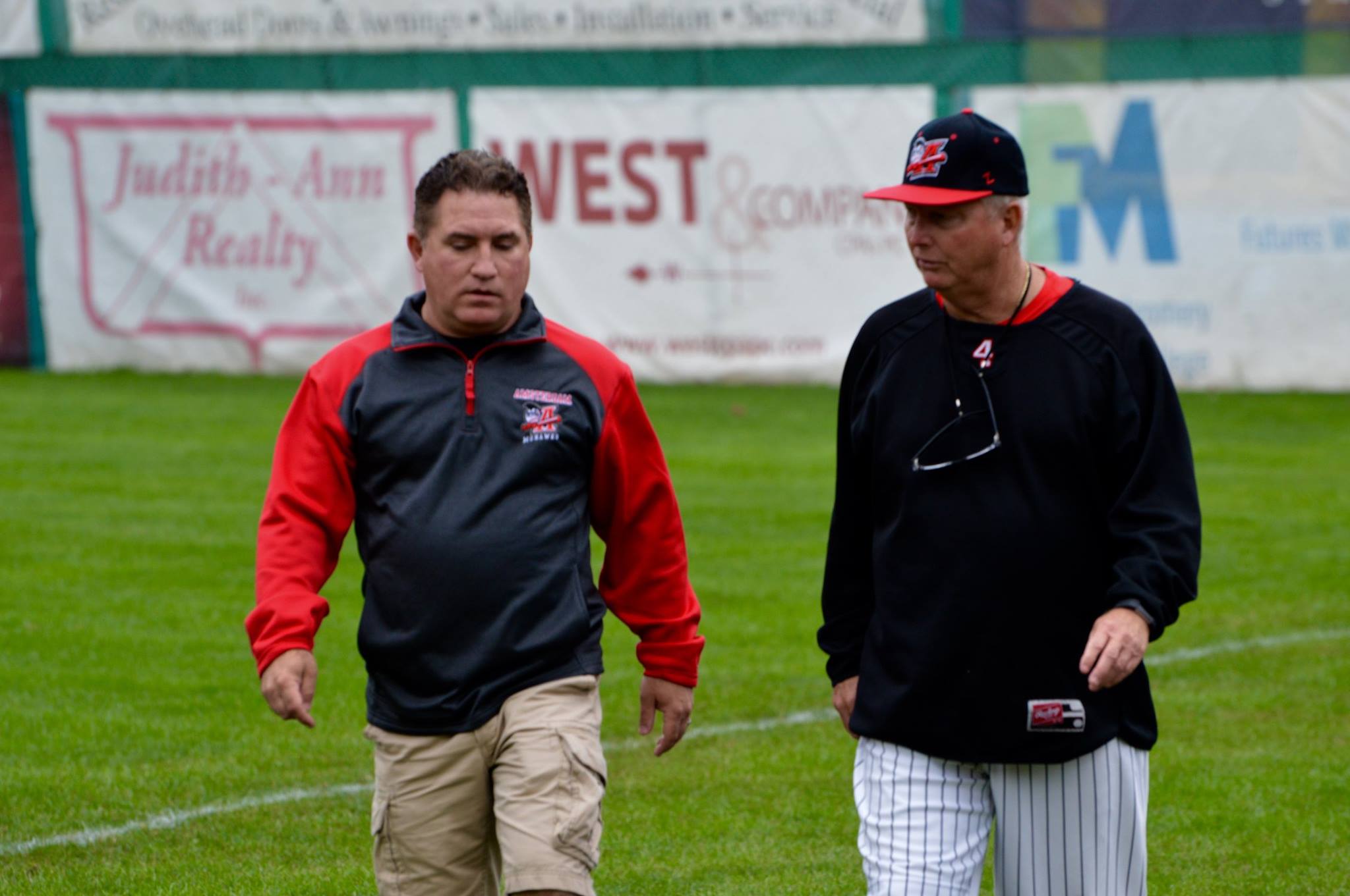 Brian Spagnola talks to Keith Griffin before a game