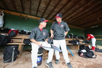 Assistant coaches Doug O'Brey and Doug Semerad review the charts