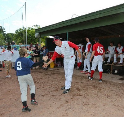 Taylor Butler (LSU) gives a kid a high five as he leaves the field