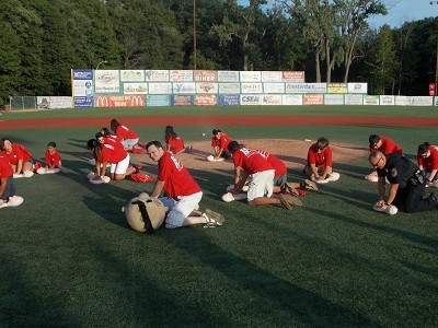 Members of Eastern Medical Supply participate in a CPR Flash Mob between innings