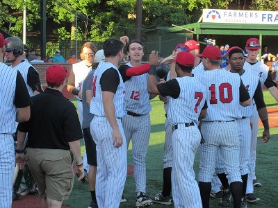 Andruw Gazzola is greeted by teammates after scoring a run off a Chris Givin single in the first inning.