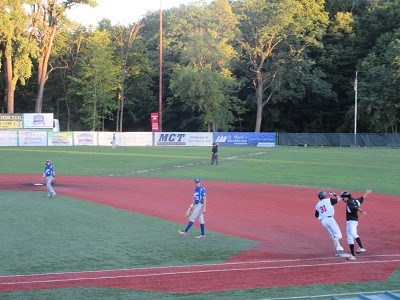 Nick Patten high fives first base coach Anthony Spataro after his third inning home run.