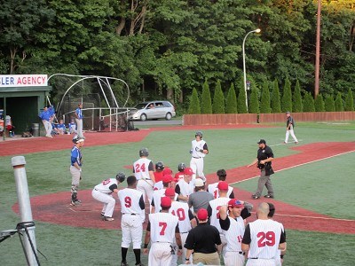 Nick Patten is greeted by his teammates after putting the Mohawks up 5-2.