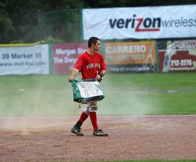 Josh Gardiner (Radford) spreads diamond dry around the second base area