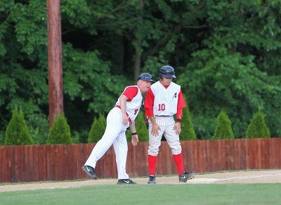 Head Coach Keith Griffin gives some instructions to Josh Gardiner (Radford) while standing on third base