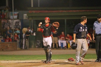 Catcher Kevin Guthrie (Brown) holds on to the ball