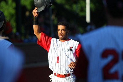 Marcus Carson of Kentucky returns to the dugout after scoring in the first inning.