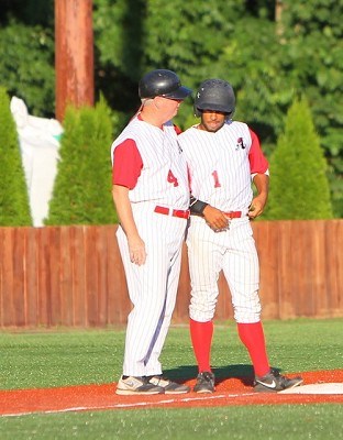 Head coach Keith Griffin speaks with Kentucky's Mascus Carson at third base during the second inning.