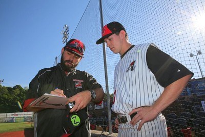 Assistant coach Karl Bithorn talks to pitcher Brad Schaenzer of Kentucky. 