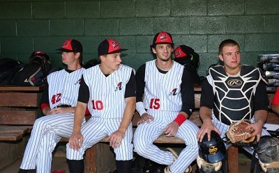 Mike Wallace (Fairfield), Andrew Rouse (Marist), Hunter Tackett (Auburn) and Tom Moore (SCCC) sit in the dugout before the game. 