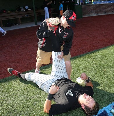 First basemen Brendan Tracy (Fairfield) gets streched out before the game.