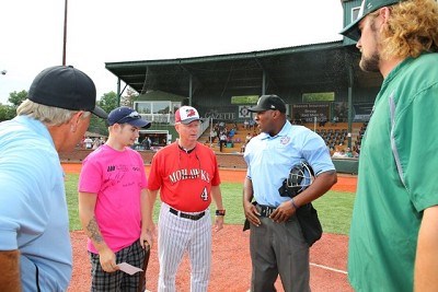 The coaches and umpires go over the ground rules prior to the start of Game 1.