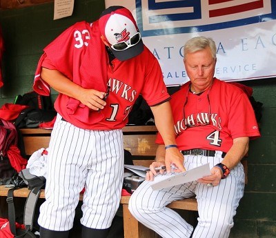 Coach Doug Semerad and Head Coach Keith Griffin go over the lineup card before the game.