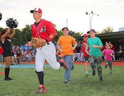 Josh Gardiner leads his baseball buddies onto the field.