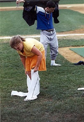 Two young fans race to dress in oversized uniforms during a between inning contest.